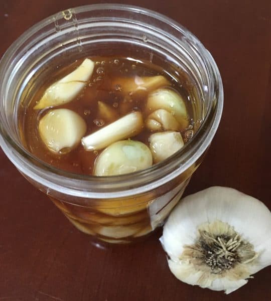 garlic honey fermenting in jar