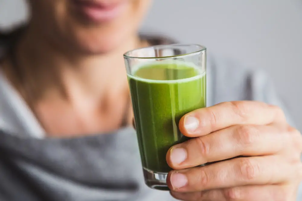 man drinking wheatgrass juice